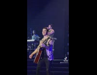 Kevin jonas walks in front of joe during concert 