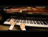 Suit guy plays on black yamaha piano 