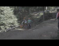 Two guys bicycles jump fall orange net 