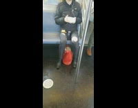 Guy eating eggs out of a bowl with toast on a subway train