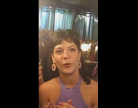 Woman looks in non reversing mirror