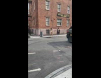 Lady spins around on street sign pole