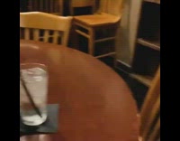 Guy eats sushi alone round table restaurant 