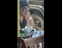 Guy money inside nostrils table outside restaurant