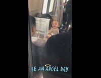 Man subway peek-a-boo baby newspaper train