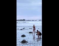 Girl middle of turtles crawl to beach