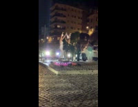 Two women dances on platform near coliseum