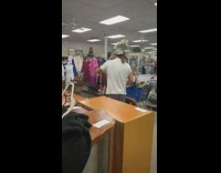 Guy adjusts decoration for grandma clothing store