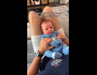 Baby held by dad has angry face