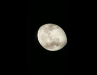 White big moon filmed through telescope at night
