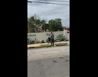 Guy poses for photo outside apartment planter