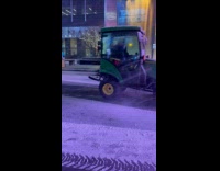 Snowplow cleans street runs after the woman