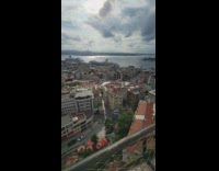 Woman with sunglasses poses on the top of the tower