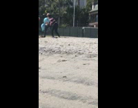 Two women blue elephant balloon tiktok beach