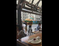 Two guys carry large hamburger halloween costume