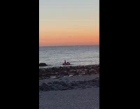 Three people pink flamingo pool float beach 