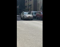Man Hammers Something Next to Wheel of His Car 