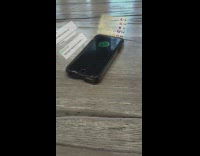 Message hologram VFX beside phone emoji music