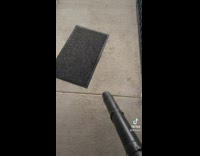 Guy uses leaf blower to straighten floor mats