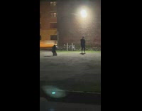 Man black coat dance under the wall lamppost