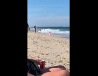 Woman in bikini sit with head bend backwards at the beach