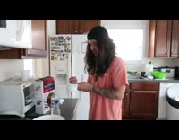 Guy pretends to pour water measuring cup 