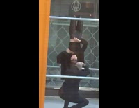 Woman hang upside down hold sunglasses scaffolding