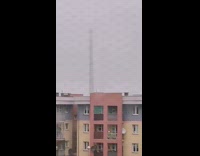 Old chimney tower gets demolished overcast building