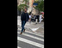 Woman white dress dances on the sidewalk