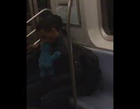 Man puts a Cookie Monster doll into his mouth on subway