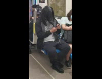 Guy sits on subway with bird mask 