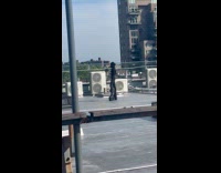 Woman all black costume photoshoot at rooftop