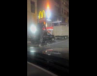 Man ride tall bike on road night