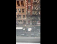 Men put large mattress into garbage truck