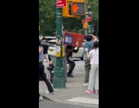 Man works out carries orange trash bin