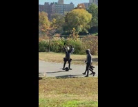 Guy butterfly wings helmet rides onewheel park 