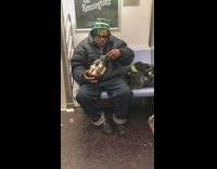 Man eats scoops of protein powder out of the container on subway train