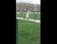 woman long white coat leans back selfie