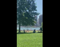Woman in bikini with an American flag near the river park