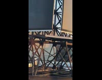 Send help written orange paint grey building