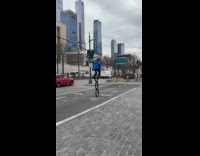 Man rides three-wheeled unicycle on the street