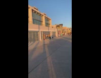 Girl stands by garage light reflector guy 
