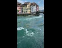 Blue river water yellow green building tower