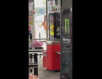 Woman orange crop top tiktok dance store door