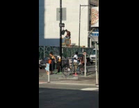 Shirtless man sit dance on traffic light