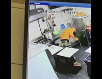 Security feed orange shirt guy slips kitchen