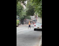 Man air jabbing while walking on street
