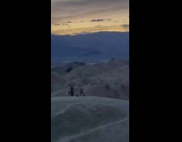 Two women wave cloth over death valley