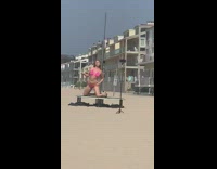 Woman pink bikini sexy dance pole beach