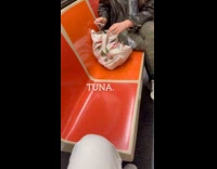 Woman ride train eat tuna from can